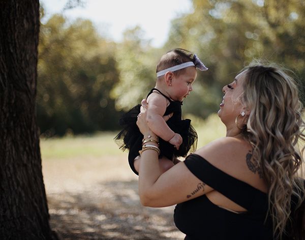 An aunt holding up her baby niece.