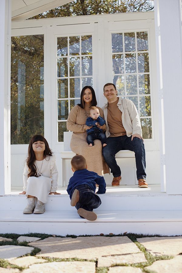 Family portrait inside of a glasshouse.