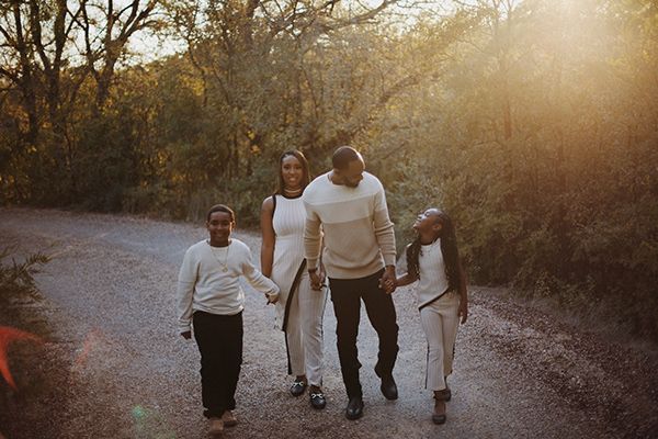 A family walking down a trail during golden hour.
