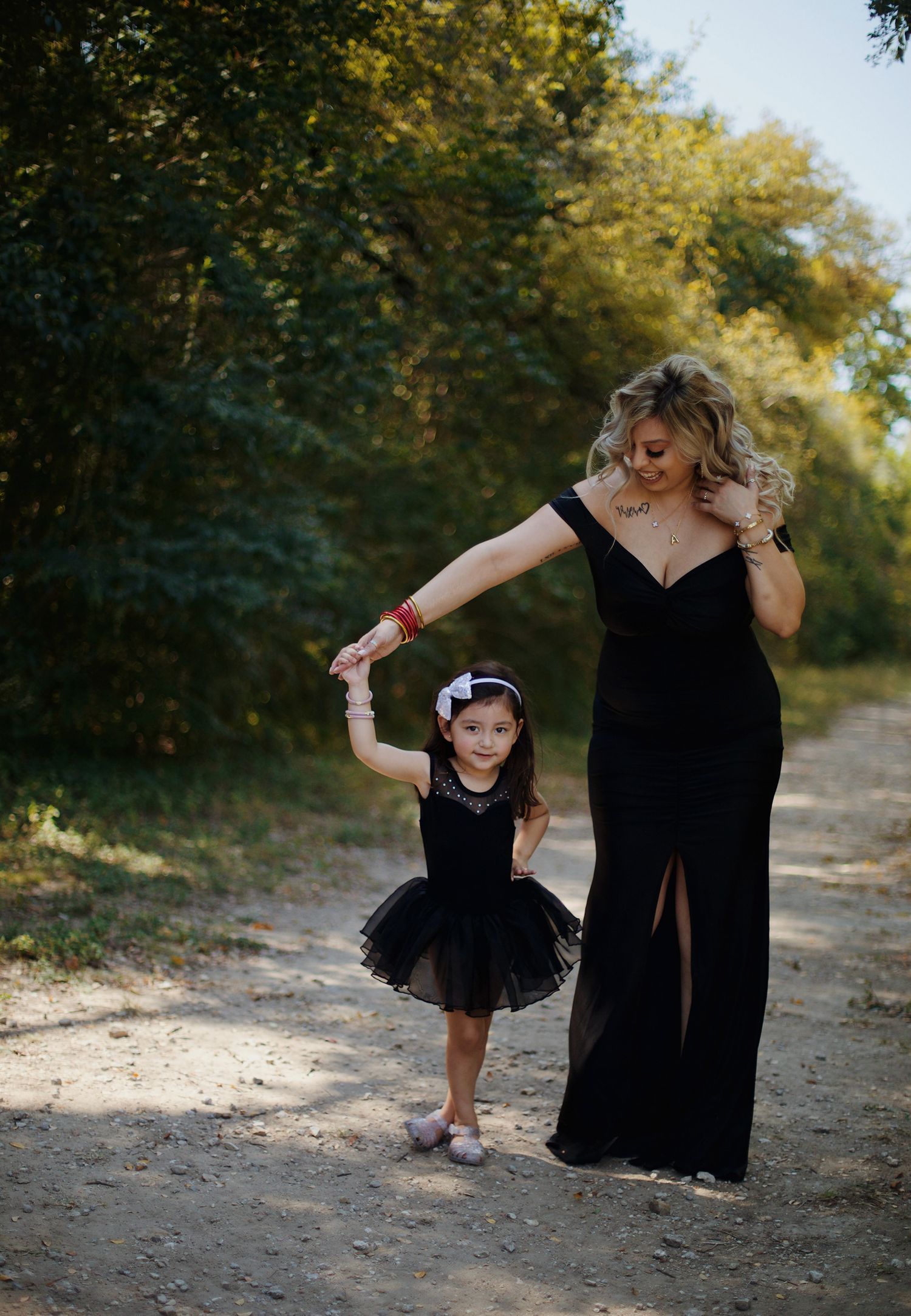 Little girl twirling and dancing with her aunt.