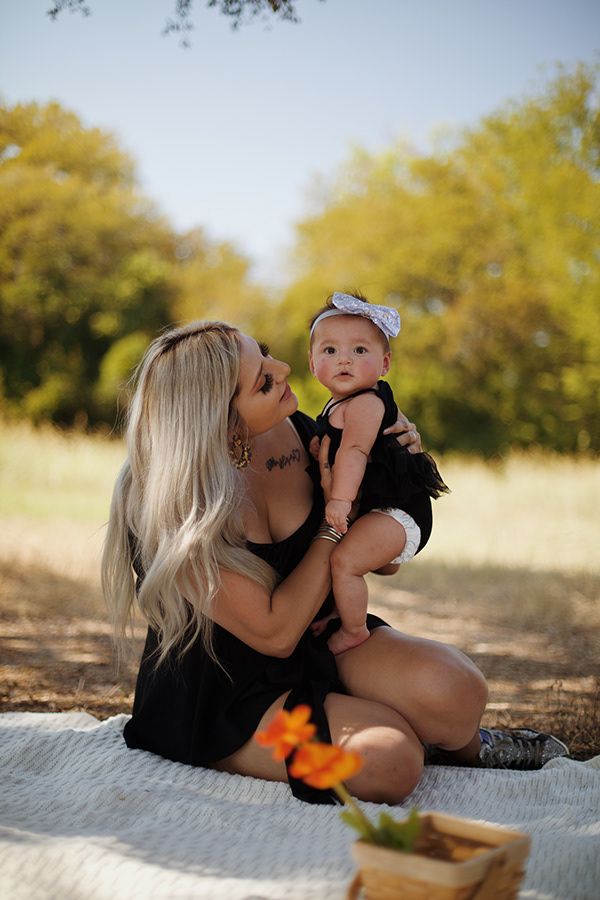 Mother holding her child and staring at her.