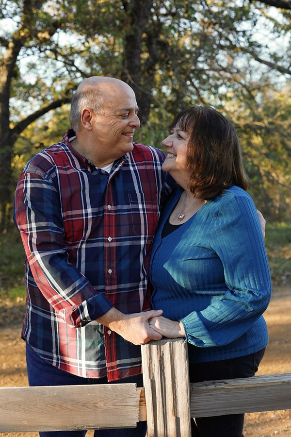 Older married couple staring at each other and smiling.