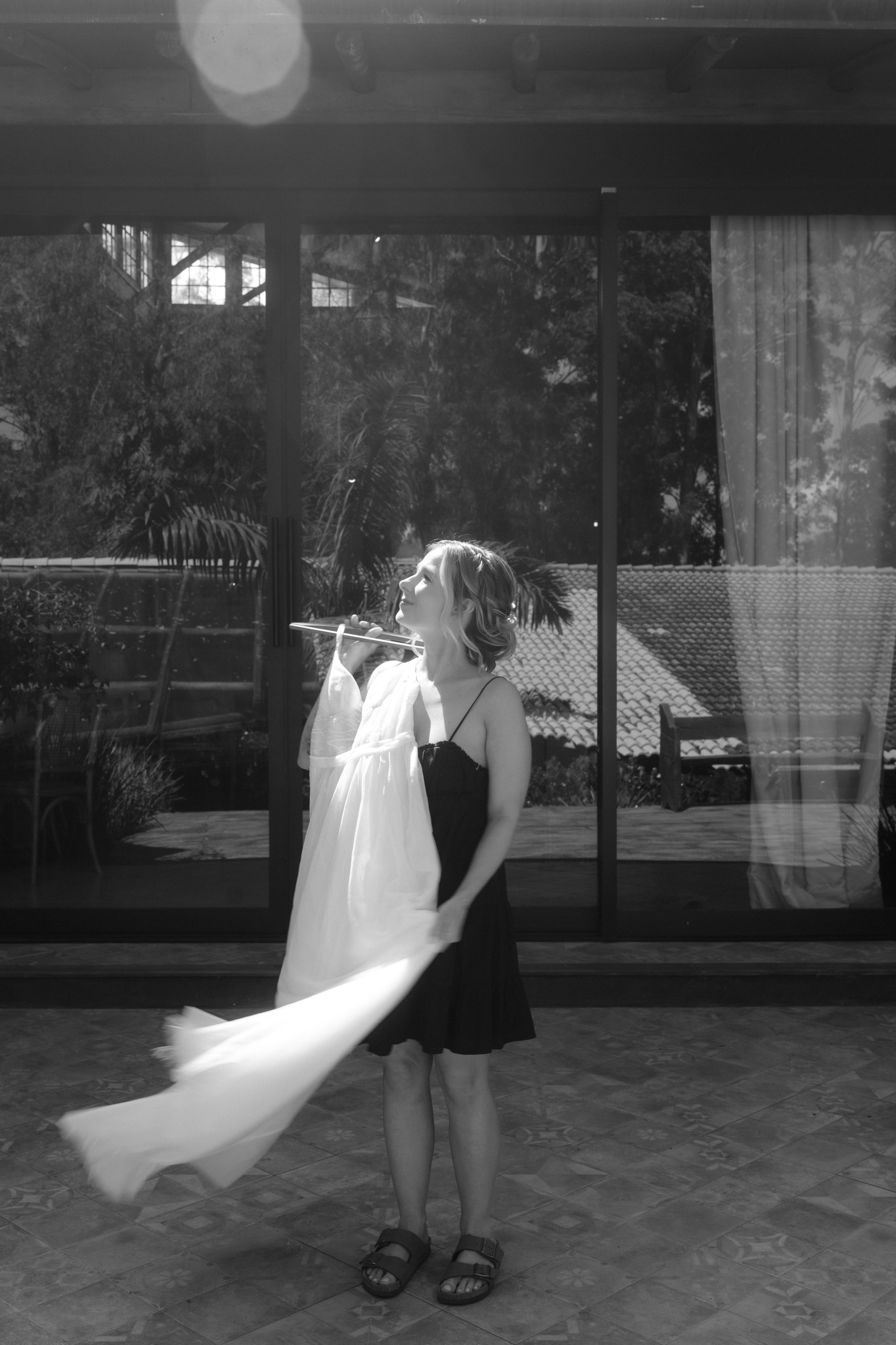 Black and white image showing movement of figures in flowing dresses.