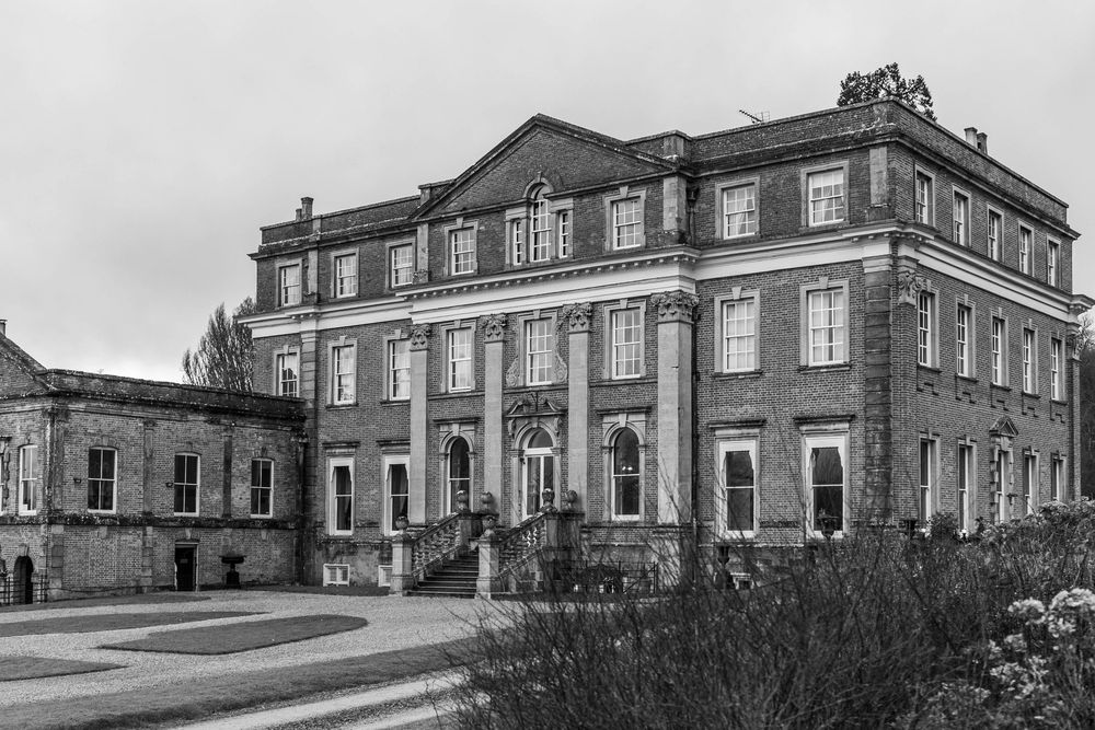 Historic brick mansion with Georgian architecture photographed in black and white.