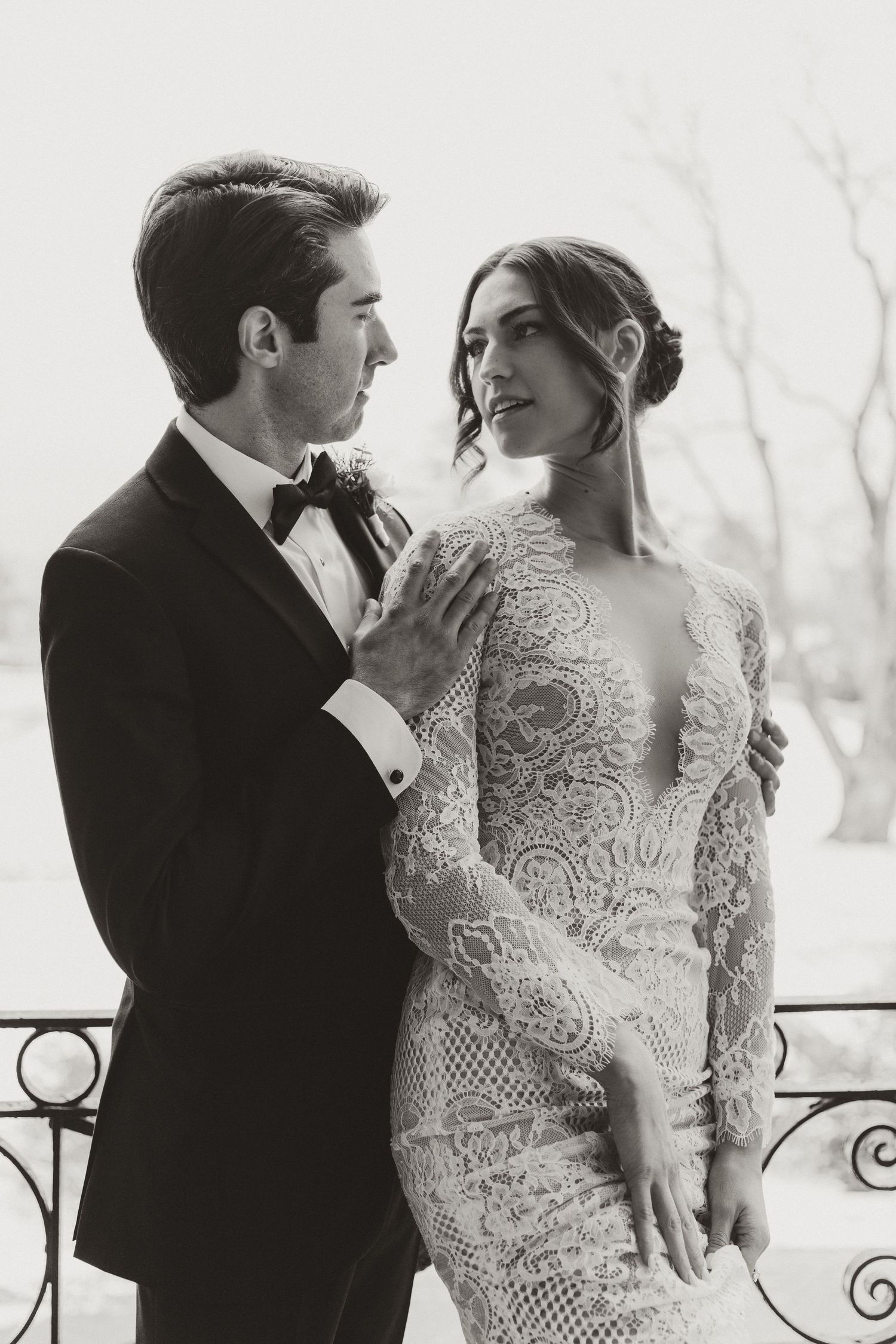 Elegant couple in formal wedding attire sharing an intimate moment.