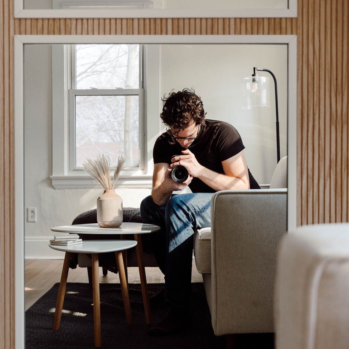 A self portrait of Andrey Boltyansky, owner of Swanky Bolt Studios, shot from a couch while looking into a mirror.