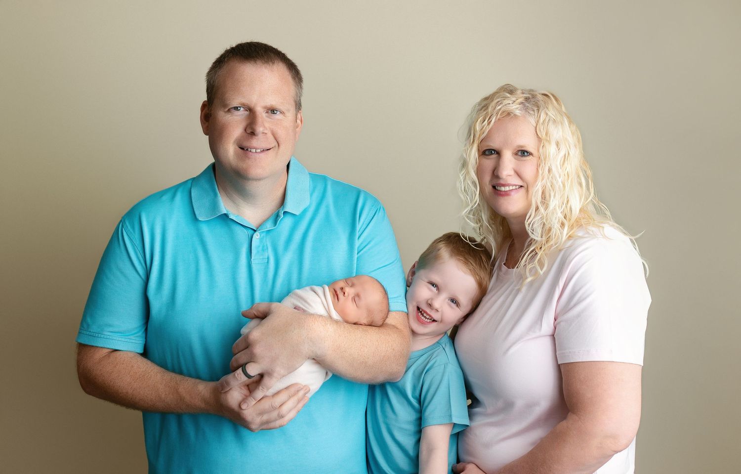 The family is looking at the camera, smiling with the newborn. Greenville SC newborn photographer, Easley SC newborn photographer