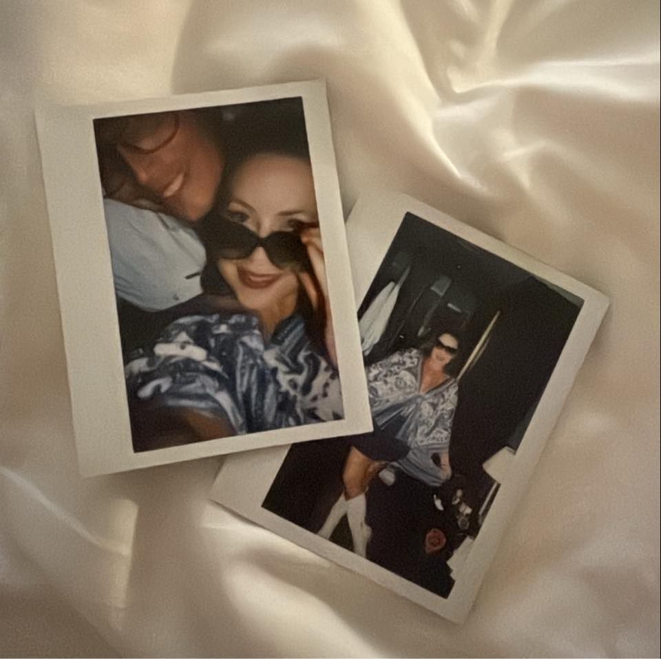 Two polaroid photos on silky white fabric display intimate casual moments.