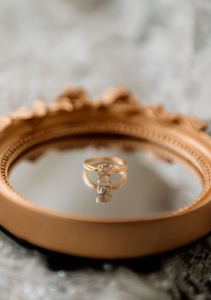 Rose gold engagement ring with diamond solitaire photographed in soft focus macro detail.