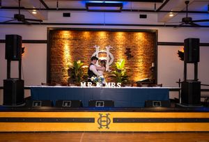Modern event venue with illuminated brick walls and decorative lighting creating a warm ambiance.