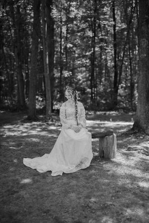 A dreamy black and white series of a flowing white dress suspended in a forest setting.