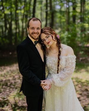 Romantic outdoor wedding photos showing couple embracing in a wooded setting.