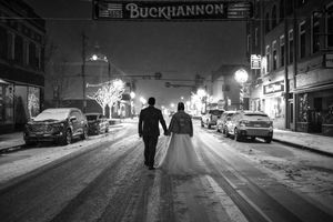 Black and white winter street scene in downtown Buckhannon with snow-covered sidewalks.