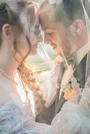 Romantic close-up wedding photos with soft sunlight filtering through showing tender moments.