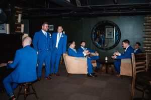 Wedding guests enjoying moments at a dimly lit indoor reception venue.