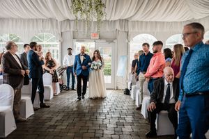 Wedding ceremony first look reactions captured in elegant white-draped venue.