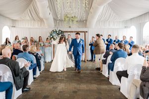 Wedding ceremony progression shots in an elegant white-draped indoor venue.