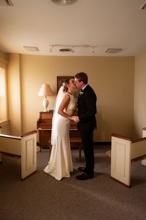 Intimate wedding moment captured in a quiet church room.