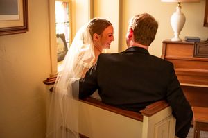 Newlyweds getting ready to leave a church sanctuary after their ceremony.