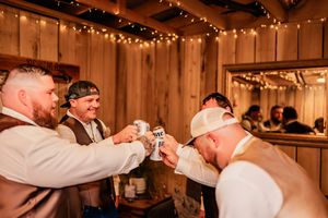 Wedding reception in a rustic barn venue with warm string lights creating an intimate atmosphere.