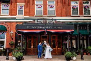Historic brick hotel exterior with American flag bunting and classic New England architecture.