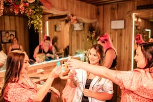 Wedding reception guests enjoying celebratory toast with glowing amber lighting.