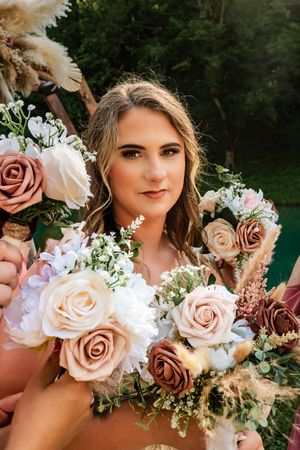 Elegant bridal bouquet featuring blush and mauve roses with white florals.