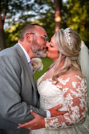 Romantic wedding moment captured in an outdoor garden setting with beautiful natural light.