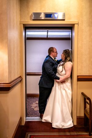 A sequence of romantic moments between a couple in formal attire captured in a hallway setting.