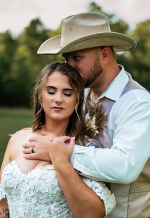 Country wedding portrait series featuring couple in rustic attire with lace dress and cowboy hat.