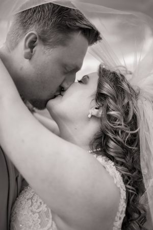 Artistic black and white romantic close-up shot of a couple sharing an intimate moment on their wedding day.