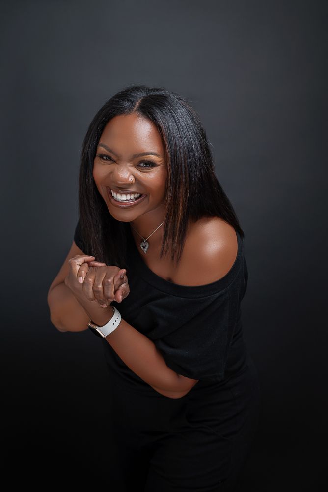 Artistic portrait series in black outfit against dark studio backdrop showing playful expressions.