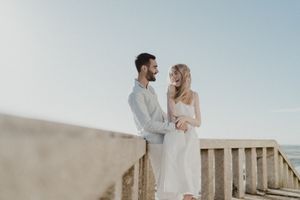 Bride and groom laughing during beach elopement in Porto
