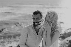 Laughter and sea spray — a real moment from a Portugal beach elopement.