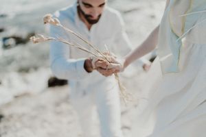 Joyful post-elopement moment by the Atlantic in Portugal