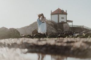 Intimate beach elopement in Portugal with barefoot couple at sunset.