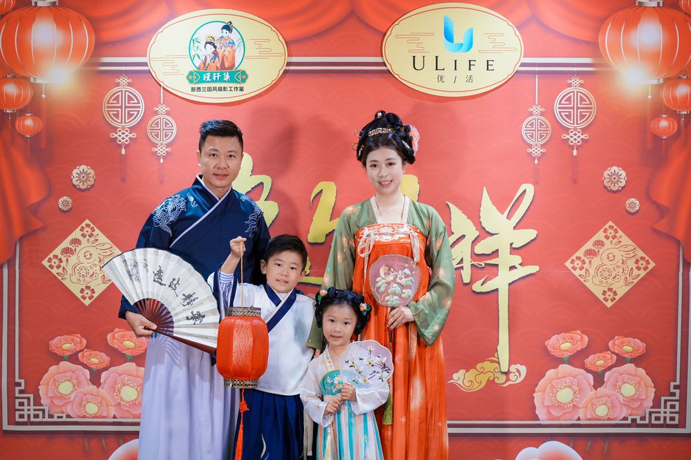 Joyful corporate event photography featuring a group in traditional Hanfu at a company party, by an Auckland event photographer.