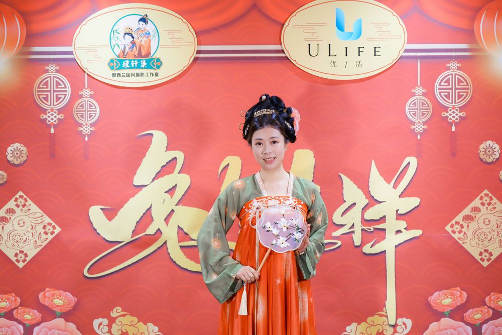 Joyful corporate event photography featuring a group in traditional Hanfu at a company party, by an Auckland event photographer.