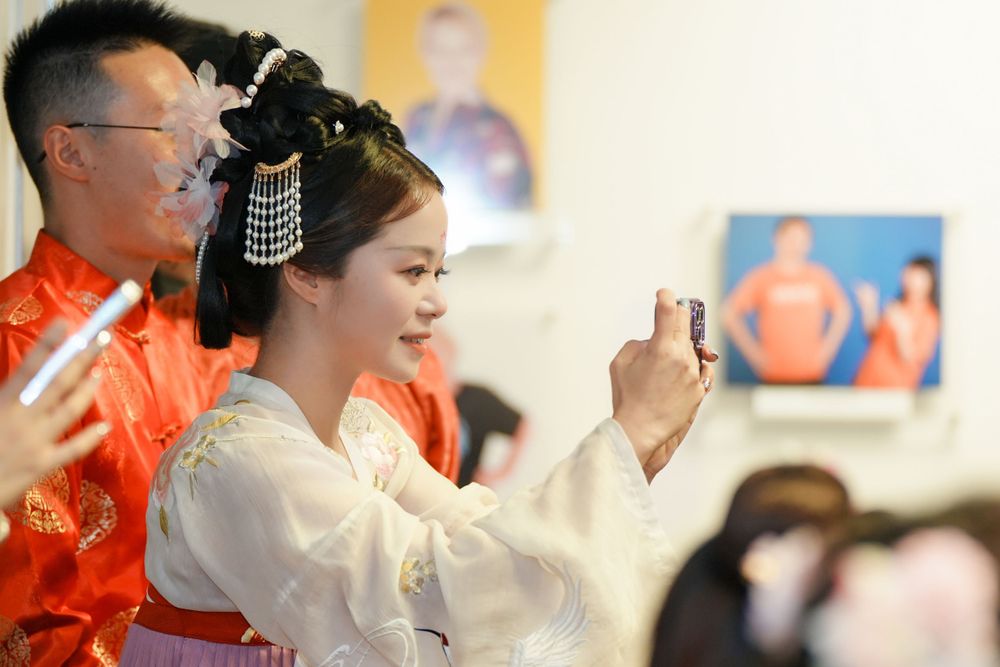 Joyful corporate event photography featuring a group in traditional Hanfu at a company party, by an Auckland event photographer.