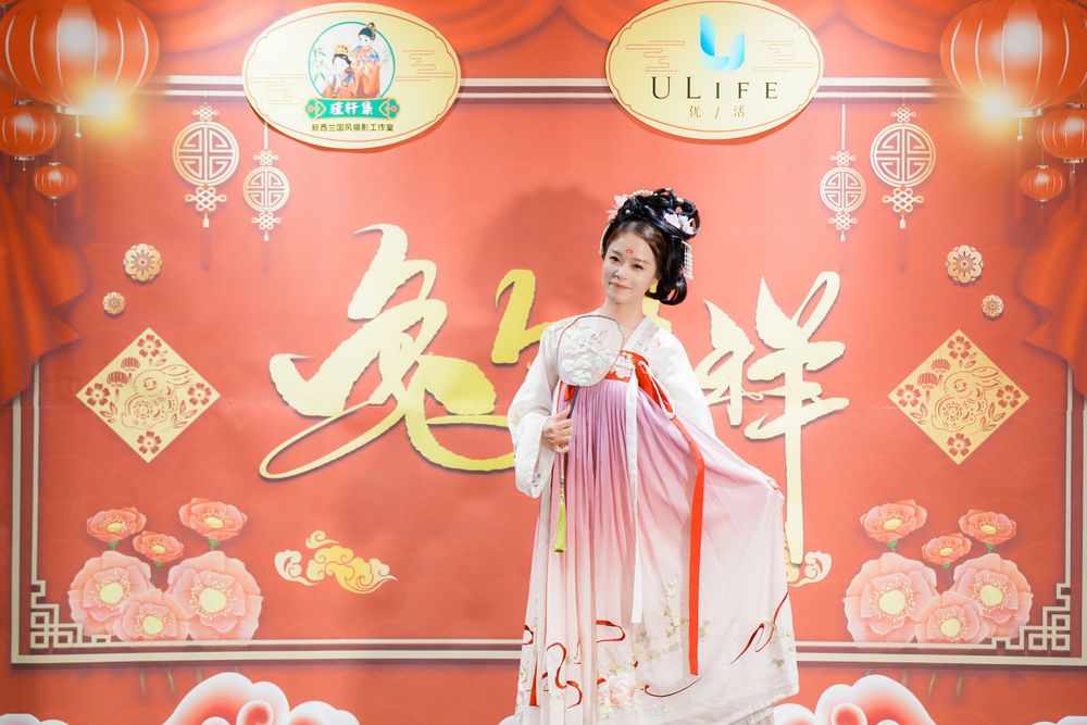 Joyful corporate event photography featuring a group in traditional Hanfu at a company party, by an Auckland event photographer.