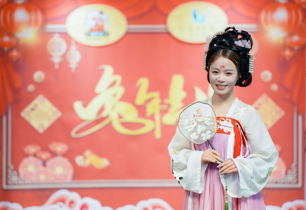 Joyful corporate event photography featuring a group in traditional Hanfu at a company party, by an Auckland event photographer.