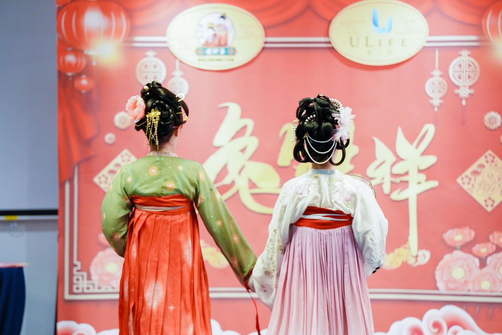 Joyful corporate event photography featuring a group in traditional Hanfu at a company party, by an Auckland event photographer.
