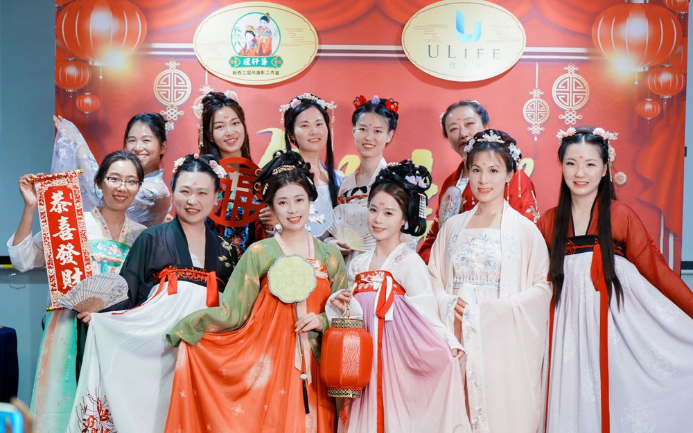 Joyful corporate event photography featuring a group in traditional Hanfu at a company party, by an Auckland event photographer.