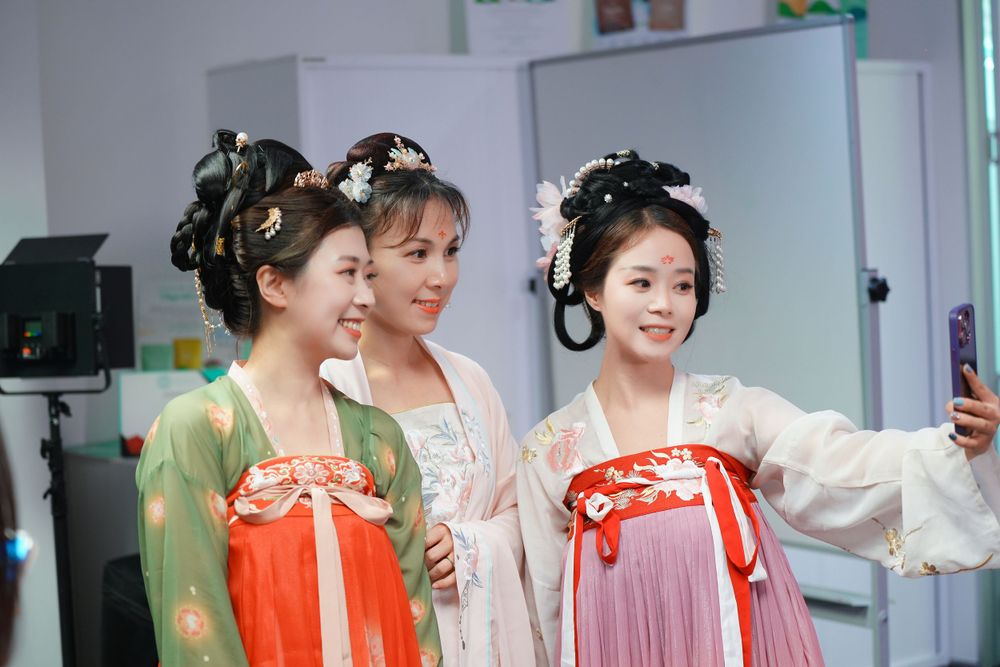 Joyful corporate event photography featuring a group in traditional Hanfu at a company party, by an Auckland event photographer.