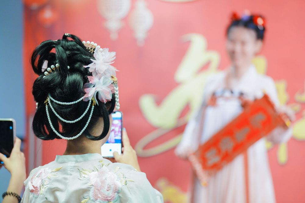 Joyful corporate event photography featuring a group in traditional Hanfu at a company party, by an Auckland event photographer.