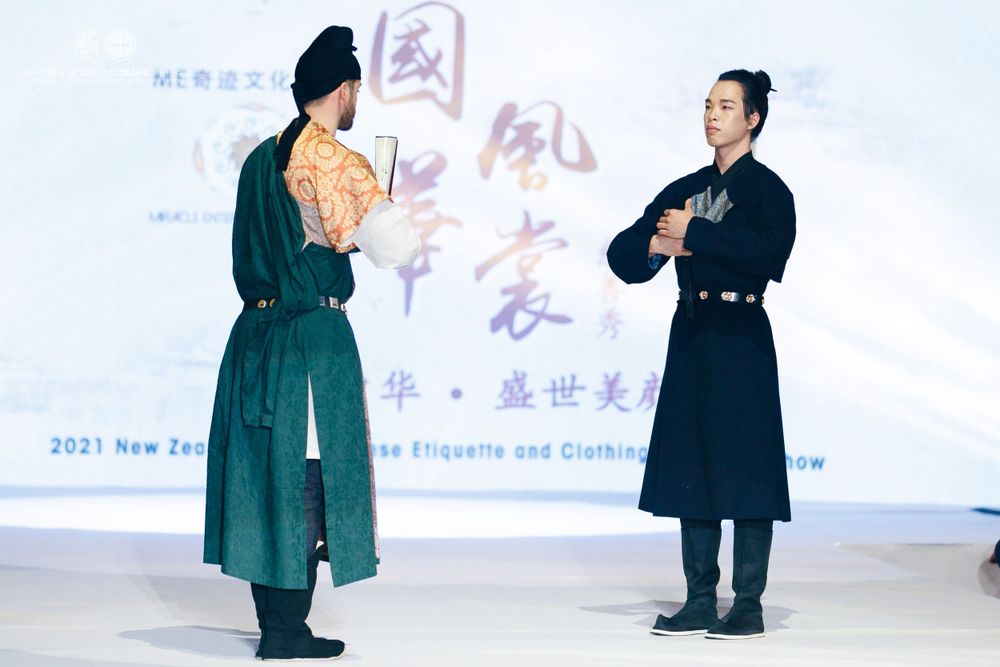Dramatic stage photography of a traditional Hanfu fashion show featuring elegant performers, by an Auckland event photographer.