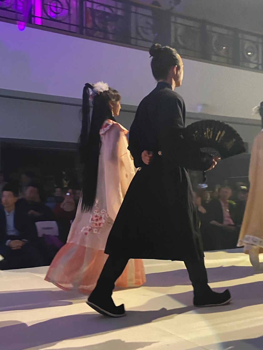 Dramatic stage photography of a traditional Hanfu fashion show featuring elegant performers, by an Auckland event photographer.