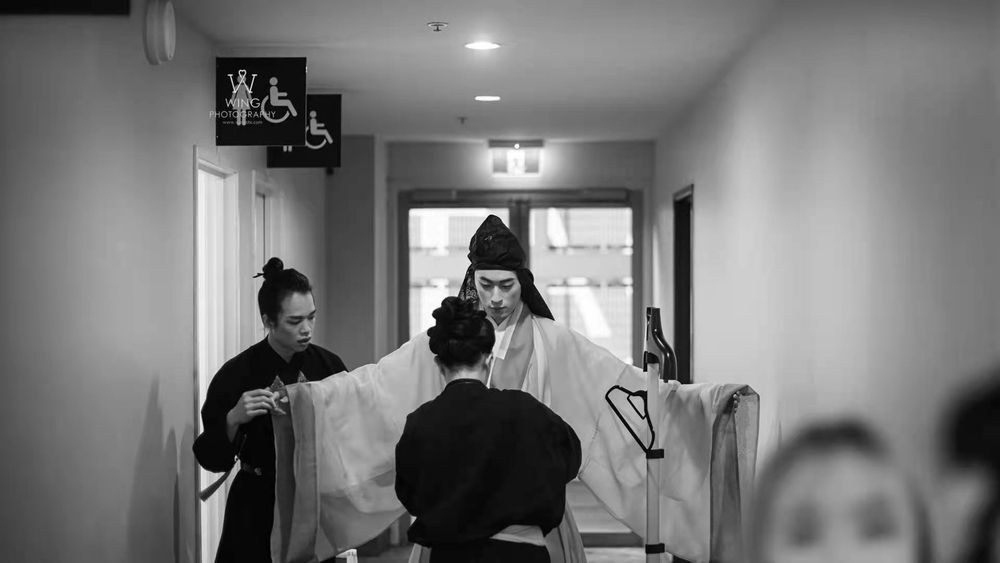 Dramatic stage photography of a traditional Hanfu fashion show featuring elegant performers, by an Auckland event photographer.
