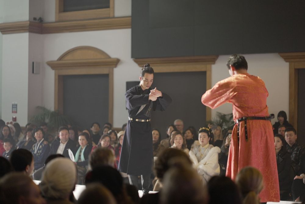 Dramatic stage photography of a traditional Hanfu fashion show featuring elegant performers, by an Auckland event photographer.