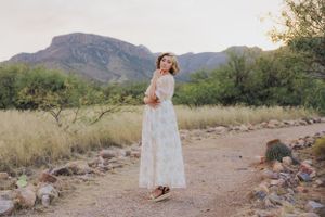 White floral dress movement captured in a series against rugged mountain landscape.
